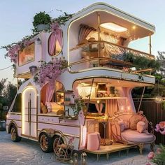 a very unusual looking house that is in the middle of some kind of street with flowers growing on it