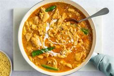 a white bowl filled with chicken and noodles