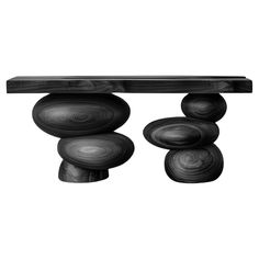 a black and white photo of some rocks on top of a wooden table with three circles