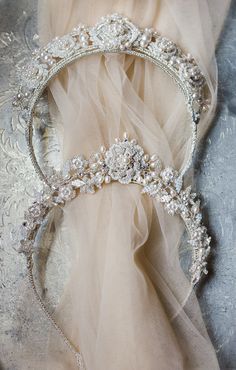 a bridal tiara laying on top of a bed