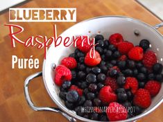 raspberry and blueberries in a white bowl on a wooden table with text overlay