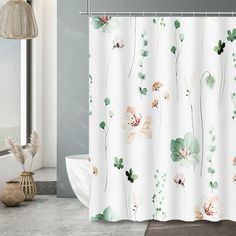 a shower curtain with flowers and leaves on it