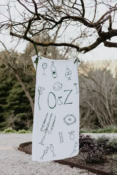 a white towel hanging from a tree in the park