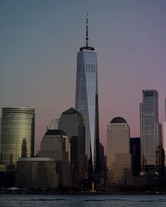 the skyline of new york city with one world trade center in the foreground