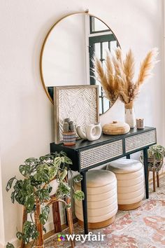 a mirror sitting on top of a dresser next to plants