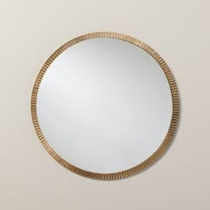 a round mirror hanging on the wall