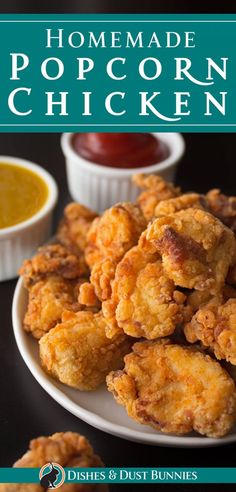 homemade popcorn chicken on a white plate with dipping sauces in the bowl behind it