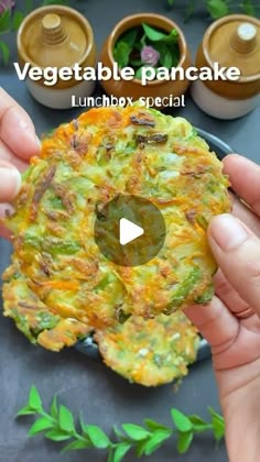 someone is holding up a vegetable pancake