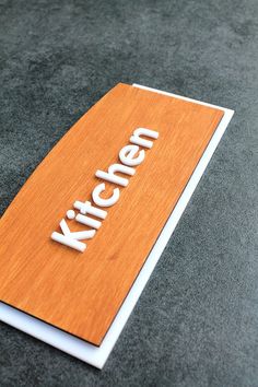 a wooden sign that says kitchen on it