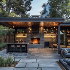 an outdoor living area with fireplace and seating