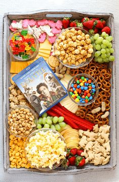 a box filled with lots of different types of food and snacks on top of it