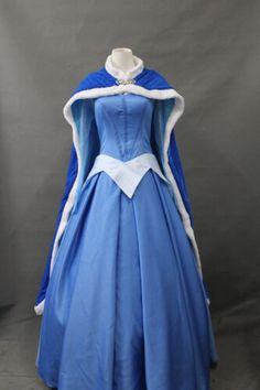 a blue dress with white trims on it