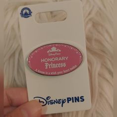 someone is holding up a pin that says honorary princesses on the front and back