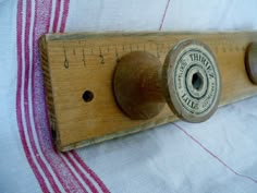 an old wooden ruler with two knobs on it