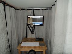 a computer monitor sitting on top of a wooden desk