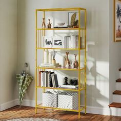 a bookshelf in the corner of a room with stairs and pictures on it