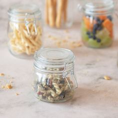 three jars filled with different types of food