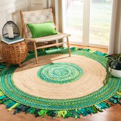 a living room area with a chair and rug on the floor next to a window