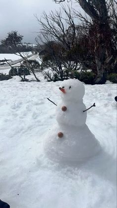 a snowman is standing in the snow with skis on