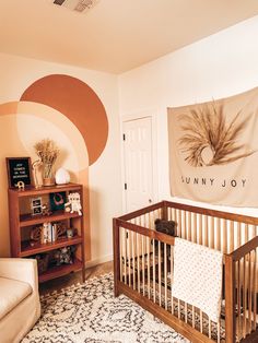 a baby's room with a crib in the corner and a rug on the floor