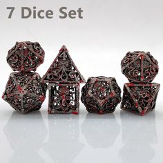 seven dice set with red and black filigrees on the sides, in front of a white background