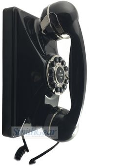 an old fashioned black phone is shown with the cord still in it's holder