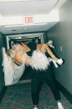 a man and woman are dancing in an exit way with their arms around each other