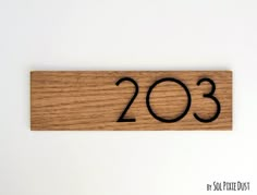 a wooden sign with the number twenty three in black ink on a white background that reads'2013 '