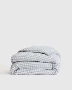 the gingham checkered sheets are folded on top of each other, and one is