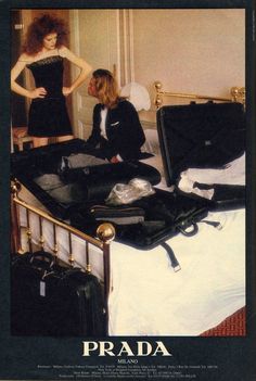 an advertisement for prada featuring two women in black dresses and suitcases on a bed