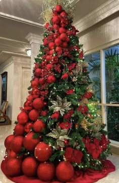 a christmas tree decorated with red balls and greenery