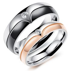 two wedding rings with diamonds on each side and one diamond in the middle, sitting next to each other