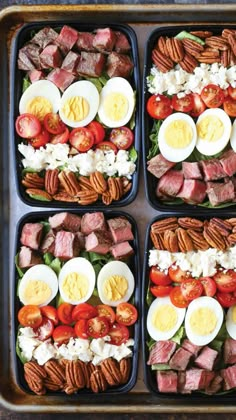 four trays filled with different types of food