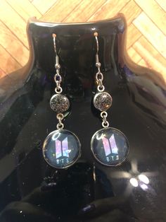 BTS Resin and stainless steel earrings.  they are a cute and fun way to show your love for BTS 💜 Bts Earrings, Holographic Logo, Kpop Merch, Steel Earrings, Summer Necklace, Resin Earrings, Jacksonville Fl, Photo Bracelet, Stainless Steel Earrings