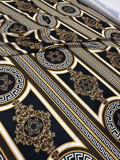 a black and gold bed spread with intricate designs