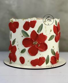 a white cake with red flowers on it