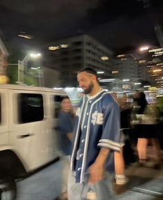 a man in a baseball uniform walking down the street