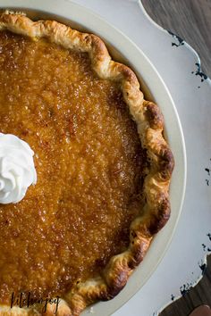 a pumpkin pie with whipped cream on top