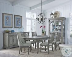 a dining room table with chairs and a china cabinet