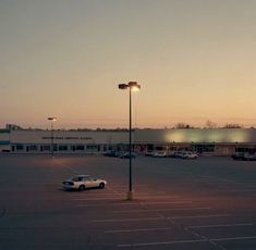 an empty parking lot with cars parked in it