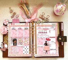 an open pink planner book with lots of things on it and decorations around the pages