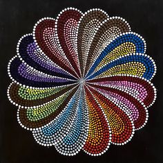 a painting with many colors in the shape of a flower on a black background,