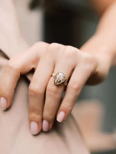 a woman's hand with a ring on her finger