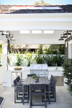 an outdoor kitchen and dining area is shown