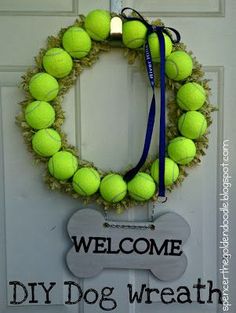 a welcome dog wreath with tennis balls on it