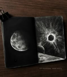 a black and white photo of an open book with the moon in the sky behind it