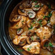 chicken and mushrooms in a slow cooker with parsley on top, ready to be eaten