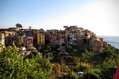 the city is on top of a hill by the ocean