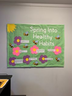 a bulletin board with flowers and bees on it that says spring into healthy habitts