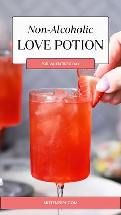 a person holding a strawberry margarita in front of a sign that says non - alcoholic love potion for valentine's day